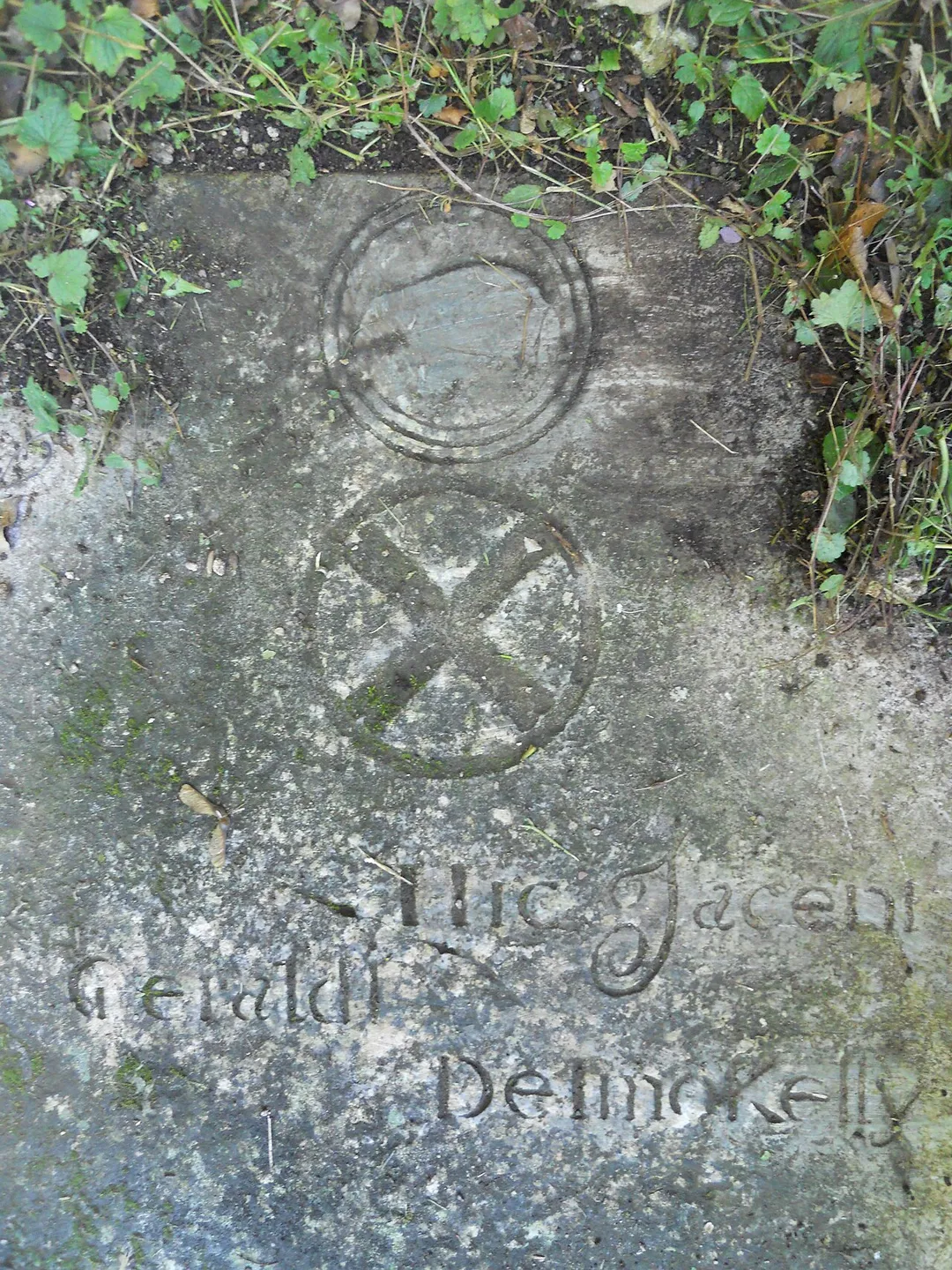 16th century tomb of the FitzGerald family, Seneschals of Imokilly, in the southeast corner of Ballyoughtera church ruins. Top picture boar coat of arms, bottom traditional FitzGerald coat. Inscription translates: "Here lies the Geraldines of Imokilly".