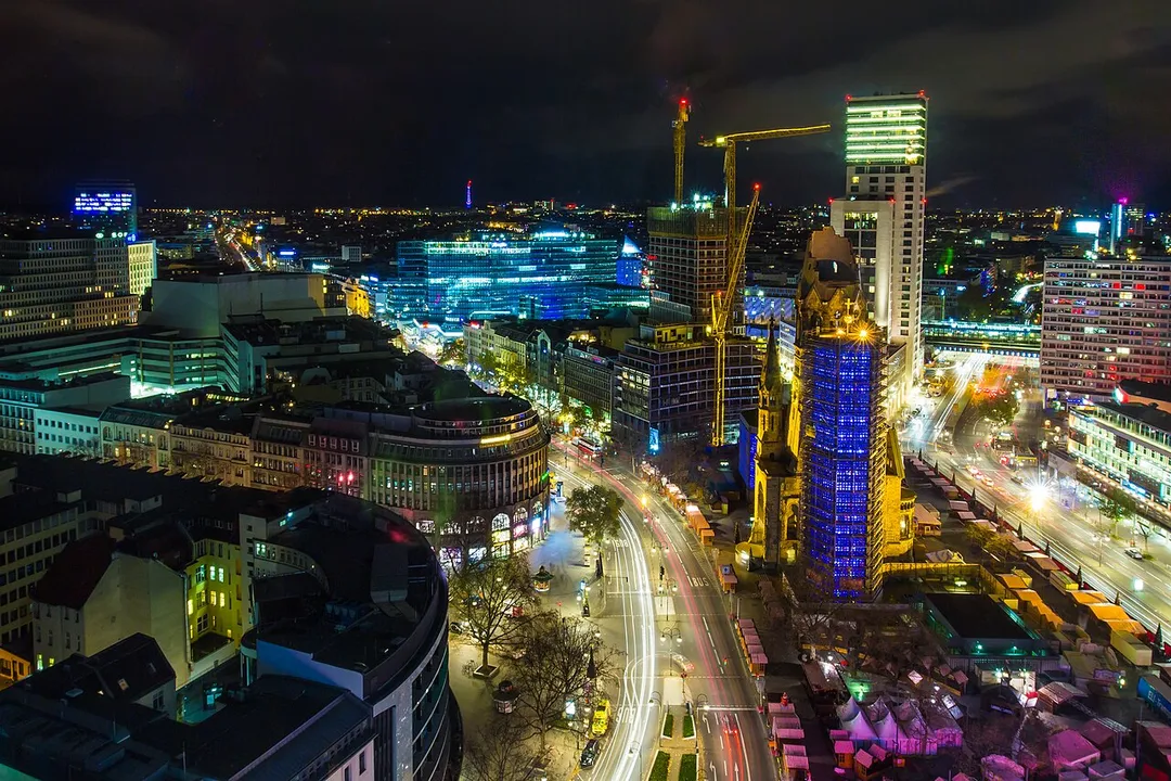 Berlin at night. View in westward direction from Europa-Center. Kurfürstendamm (in the middle) and christmas market at Breitscheidplatz around the Kaiser Wilhelm Memorial Church November 2015. The christmas market is under construction. Opening day was November 23.