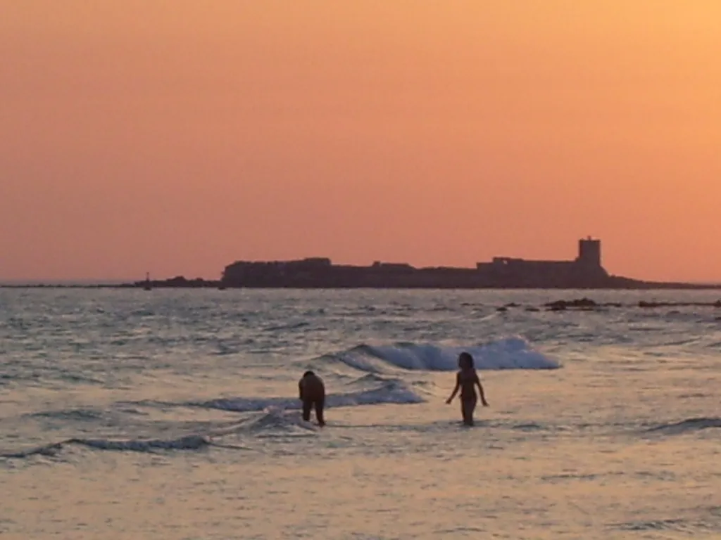 View, at sunset, of the castle of Sancti Petri (belonging to San Fernando) from the Playa de la Barrosa, in Chiclana de la Frontera, (Cádiz, Spain).
