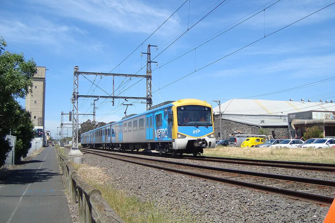 Upfield train past the silo. View south along the Upfield Shared bike pathway looking towards Tinning Street