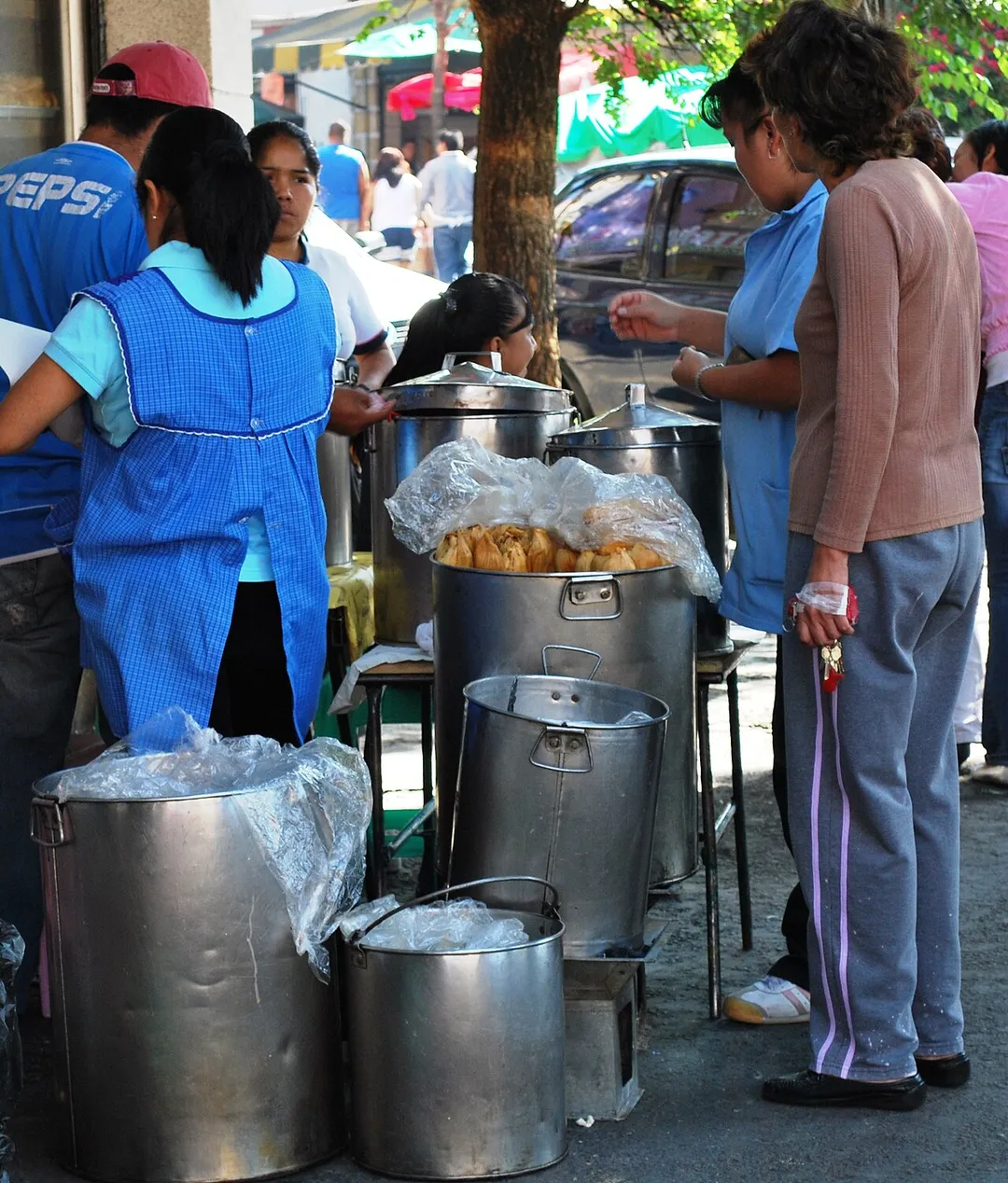 Buying tamales on the street at the intersection of Jose Maria Roa Barcenas and Simon Bolivar in Colonia Obrera in Mexico City