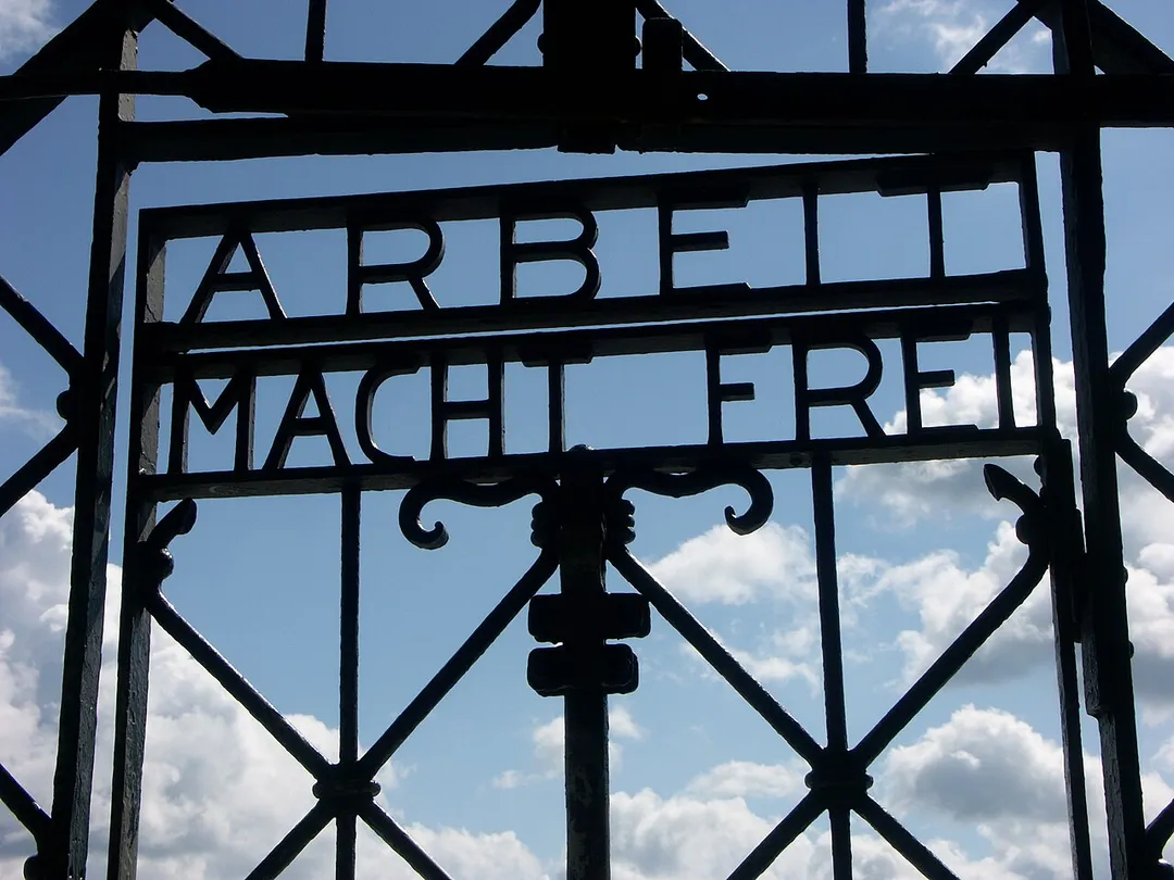 Detail of the main gate at Dachau concentration camp in Germany, displaying the famous "Arbeit Macht Frei" slogan.