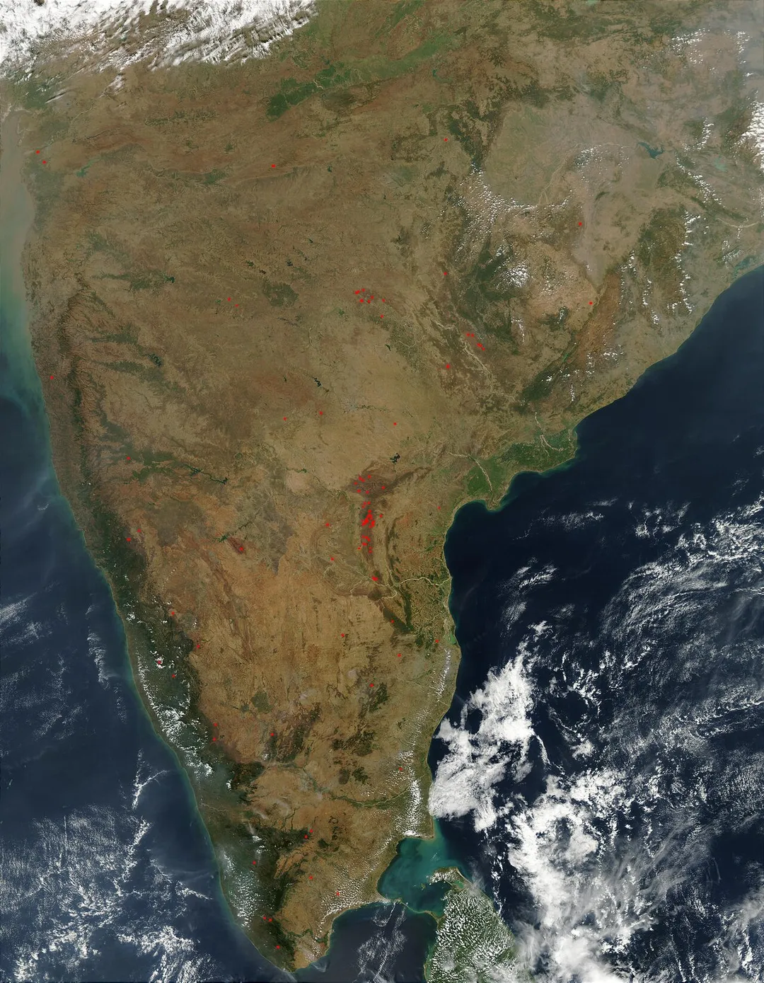 Southern India photo from space (NASA) Numerous scattered fires (red dots) were detected by the Moderate Resolution Imaging Spectroradiometer (MODIS) on the Aqua satellite across southern India on January 31, 2003. Fire are especially concentrated in the Nallamala Hills region of the Eastern Ghats along India’s Indian Ocean coast (right). Fires also drape down the Western Ghat Mountains on India’s Arabian Sea coast (left).