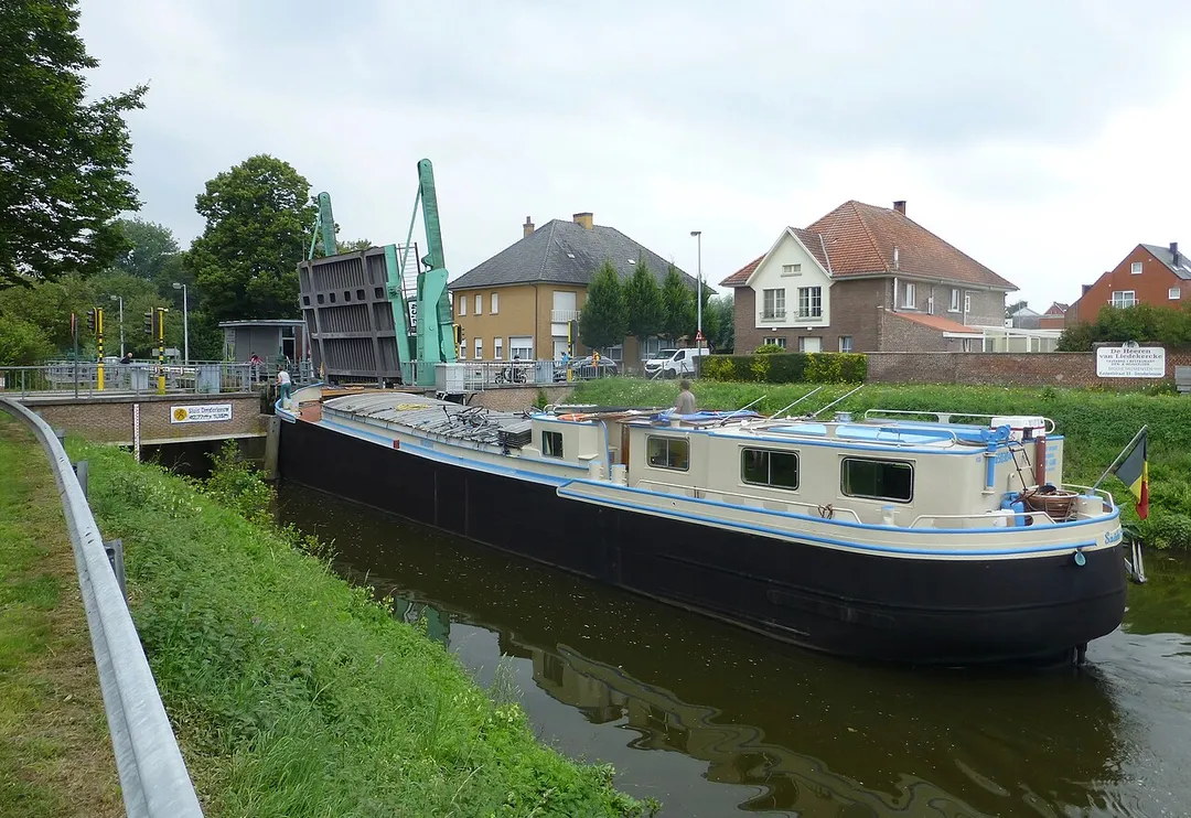 Lock of Denderleeuw with raised drawbridge to allow entry of a vessel