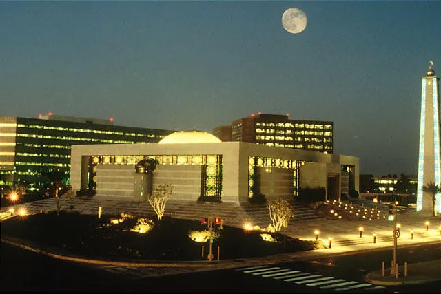 Saudi Aramco's core area which includes the headquarters and office buildings in Dhahran city.
The buildings which appear in this picture are the Al Mujamma Mosque (foreground), Administration buildings (right background Two Towers), Old Admin Building (right background shown between Mosque and Minaret) and Engineering building (left background).  Exploration and Production (EXPEC) building and Exploration Computing Center are behind the Engineering building and are not visible in this photo.