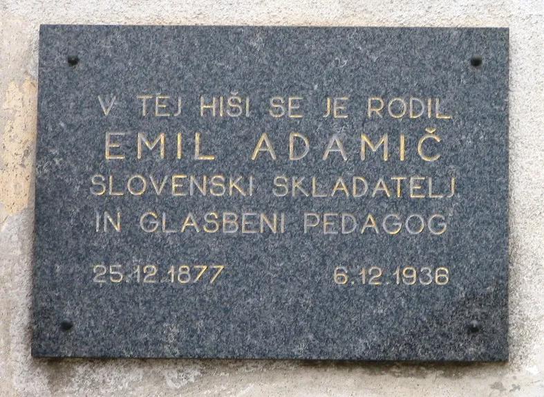 Plaque in Dobrova: "The Slovenian composer and music teacher Emil Adamic( was born in this house (25 Dec. 1877–6 Dec. 1936)"