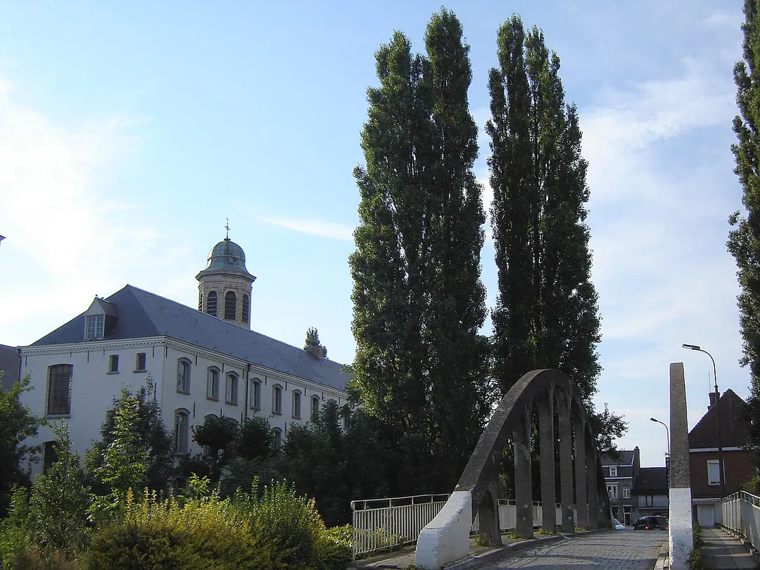 View on Drongen, with the "Oude Abdij" (Old Abbey), the tower of the Church of Saint Gerulph, and the Pontbrug bridge over an arm of the river Lys. Drongen, Gent, East Flanders, Belgium