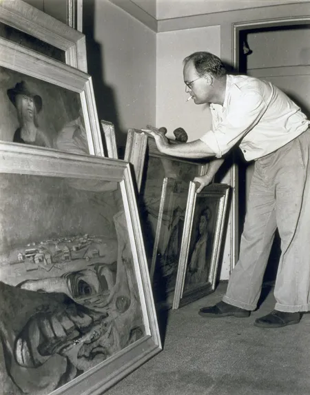 Photograph of Australian painter Russell Drysdale with some canvases, taken by Max Dupain
