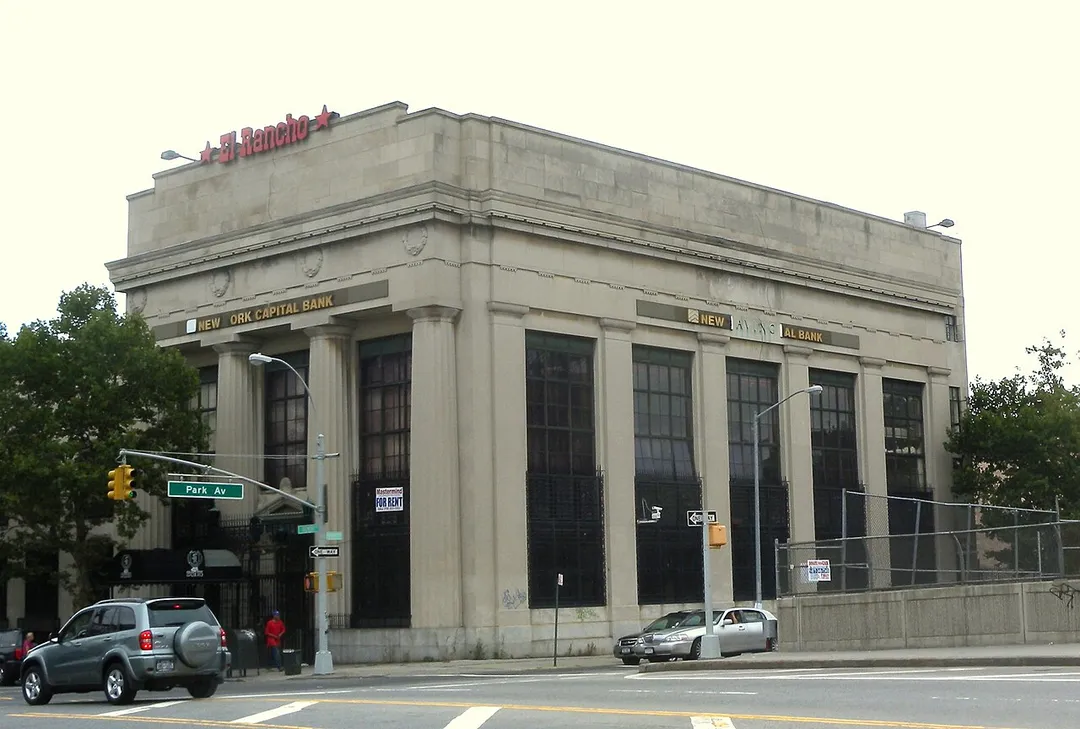 Looking northwest across Park and Tremont Avenues in East Tremont, at former bank building on a cloudy morning.