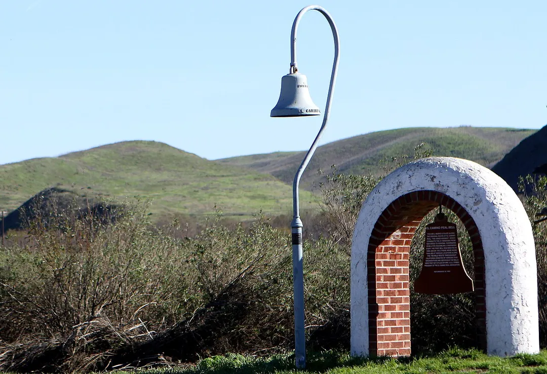 Along Camp Pendleton’s Vandegrift Boulevard stands one of California’s many historic El Camino Real bells that has been around long before any Marine or sailor occupied the land. The bell symbolizes the trail used by the Franciscan Padres on the journey to Northern California from Mexico in the 1800s. The Padres were Catholic priests sent by the King of Spain to convert Native Americans of California to Catholicism, in order to become citizens of Spain. The bell on base stands where the trail crosses Vandegrift Boulevard, just inland of the main gate.