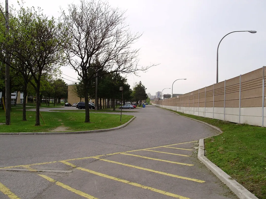 A housing development in the neighbourhood of Englemount-Lawrence in Toronto, Ontario, Canada. The standing wall acts as a barrier between the development and Allen Road, immediately behind it.