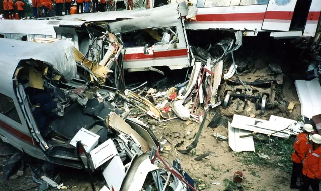 Eschede train disaster. This image was taken with a small hand held photo camera and shows the severe destruction of the rear passenger cars that were pushed into each other and into a road bridge.