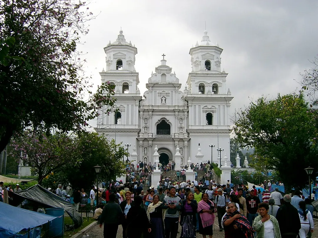 Frontal view of Basilica in Esquipulas, Guatemala on January 14, 2005 - a day before the holiday of Black Christ. During this holiday, he city is crowded by visitors. Some women wear traditional Mayan costumes. Blue tents on both sides of the main path are occupied by poor pilgrim families, which cannot afford a hotel.
This picture is my own work (--Sapfan 17:48, 17 July 2006 (UTC)) and was previously published on http://railtrips.euweb.cz/c_sal_foto1_en.html .