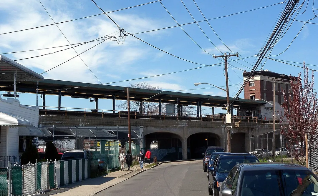 Looking northeast along B22nd Street at the terminal station on the Far Rockaway subway viaduct on a sunny early afternoon.