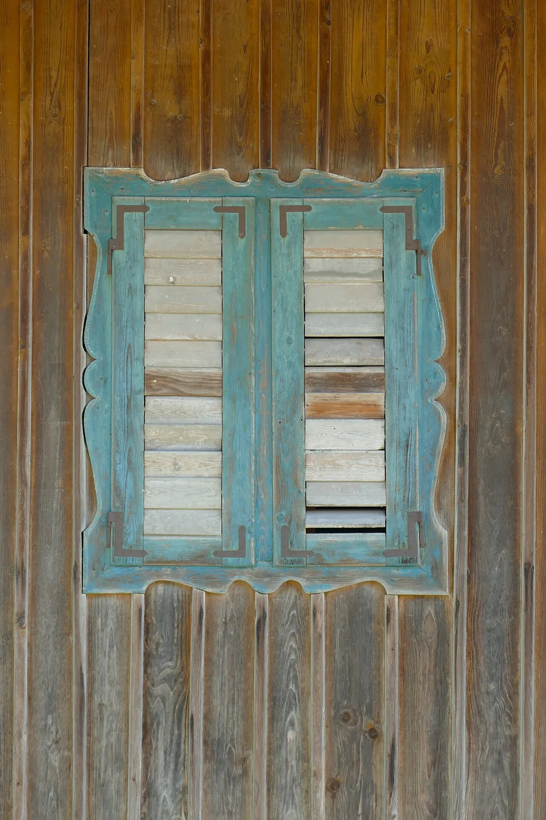 A traditional shuttered window at the house Feldkirchen 4 in Feldkirchen, community of Egling in Bavaria.