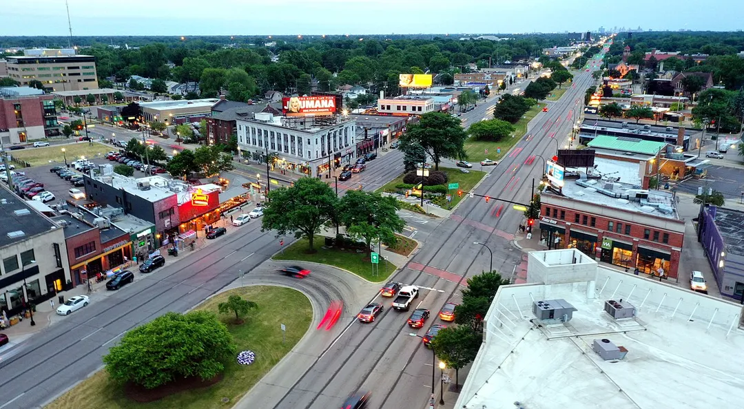 The core of Ferndale, Michigan's downtown area is the intersection of 9 Mile Rd and Woodward Avenue, north of Downtown Detroit (which can be seen on the horizon).