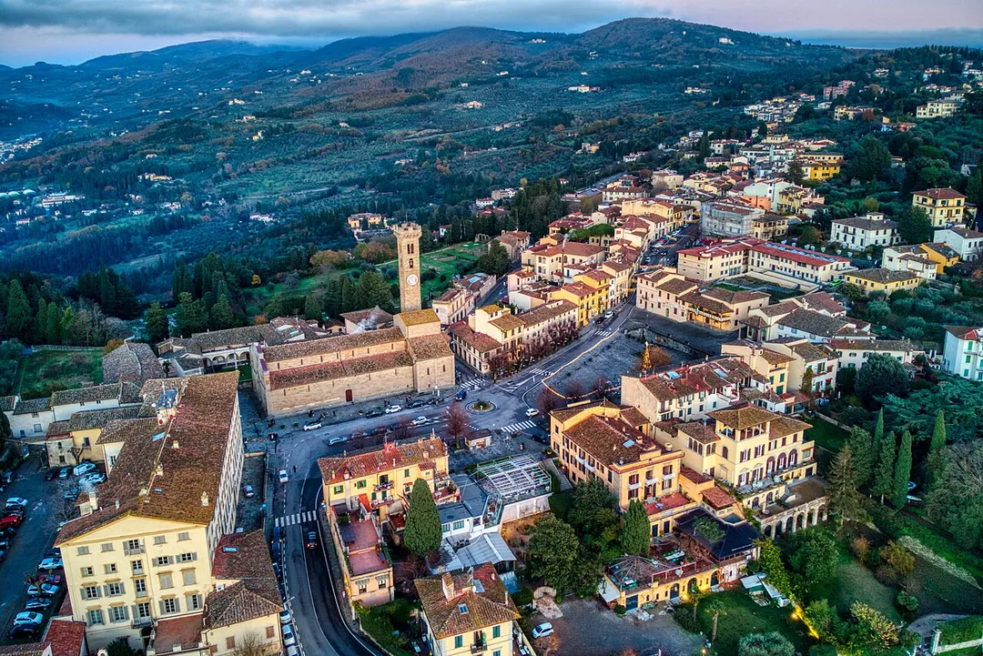 Aerial view of Fiesole, FI, Italy, including Piazza Mino, the cathedral, diocesan seminary, episcopal palace, Etruscan ruins, Praetorian palace (town hall), and Santa Maria Primerana Church.