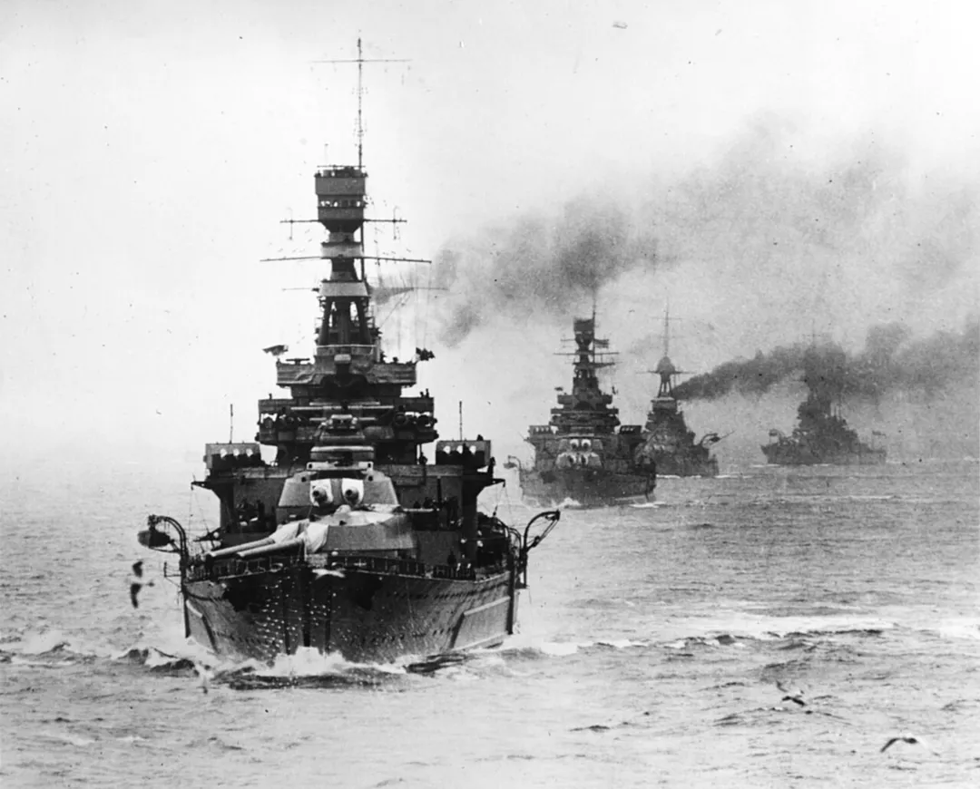 The battlecruiser HMS Repulse leading other Royal Navy capital ships during maneuvers, circa the late 1920s.

The next ship astern is HMS Renown. The extensive external side armor of Repulse and the larger "bulge" of Renown allow these ships to be readily differentiated.
