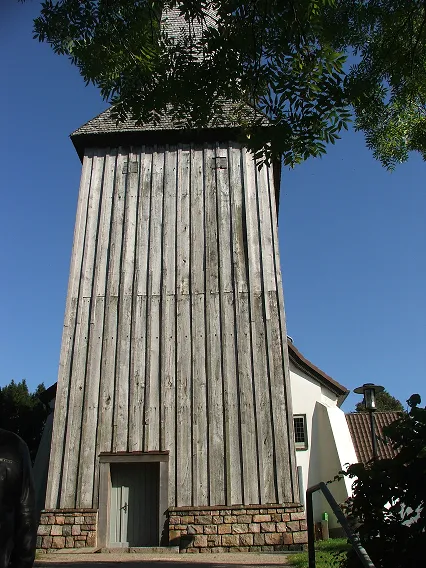 Front of the Lutheran Church in Flintbek, Germany showing impressive wooden tower surmounted by a wooden steeple.  Photo taken by editor.