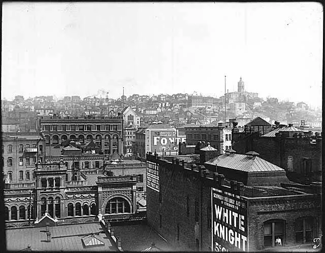 The photographer may have been standing atop the Daily Journal of Commerce Building to capture this view of turn-of-the-century Seattle.  Looking east and slightly south from Post Alley between Cherry and Columbia, many of the city's prominent buildings are visible, including the King County Courthouse on the right.
Original photo by Anders B. Wilse, acquired by Webster &amp; Stevens.

Signs in image: Schwabacher Bros. &amp; Co. Inc. Distributors - White Knight 5-cent [Cigars?]. F.W. [...ick] 703 First Av., The American Clothier. Treen Shoe Co., 707 First Av. Grand Opera House. America's Finest for 5 Cents - Fontana Cigars.

Handwritten on sleeve: Panorama "C."
Subjects (LCTGM): Business districts--Washington (State)--Seattle