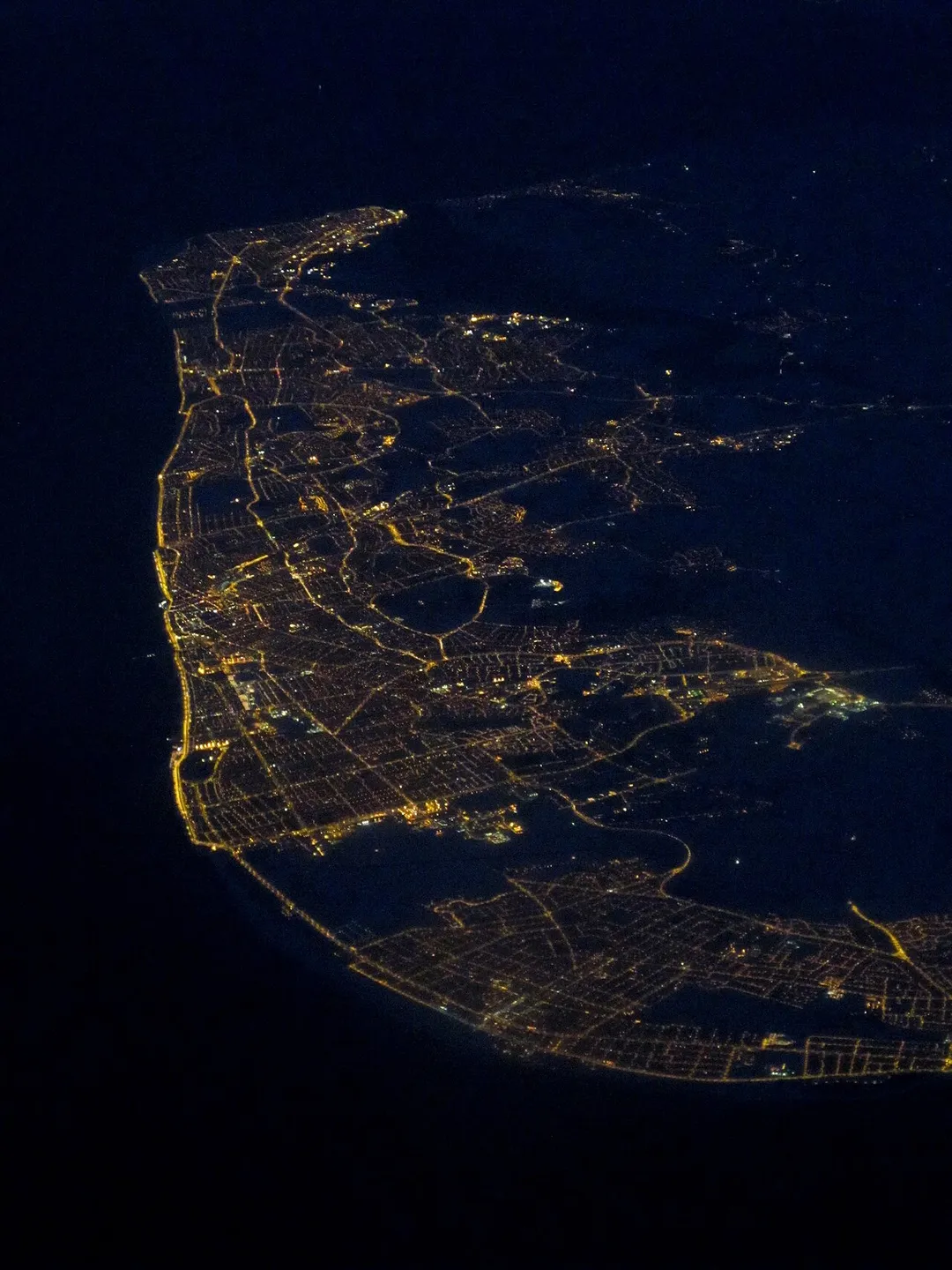 Night-time aerial photograph of the Fylde, a coastal plain in western Lancashire, England. Blackpool can be seen in the left middle-ground of the photograph.