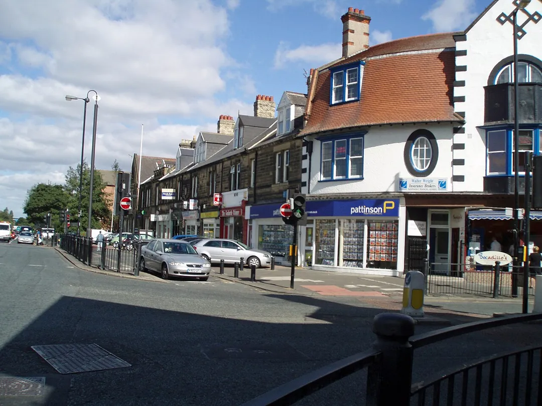 This is a view of Gosforth High Street, Newcastle upon Tyne, England. The image shows the old fire station and the shops that occupy the building.