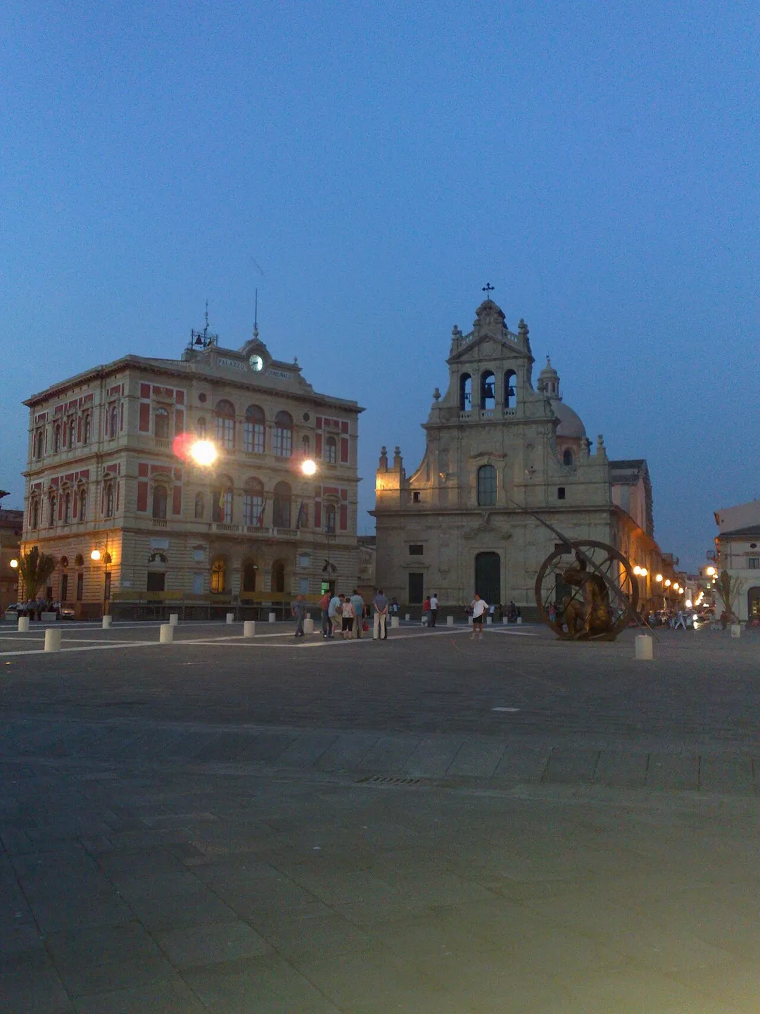 The beatiful public square of Grammichele, a small city in the province of Catania. In the photo the town hall, the cathedral and the new sundial.