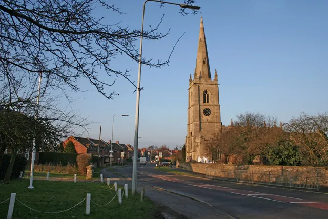 High Street, Great Gonerby, Lincolnshire. On the right are the tower and spire of St Sebastian's parish church.