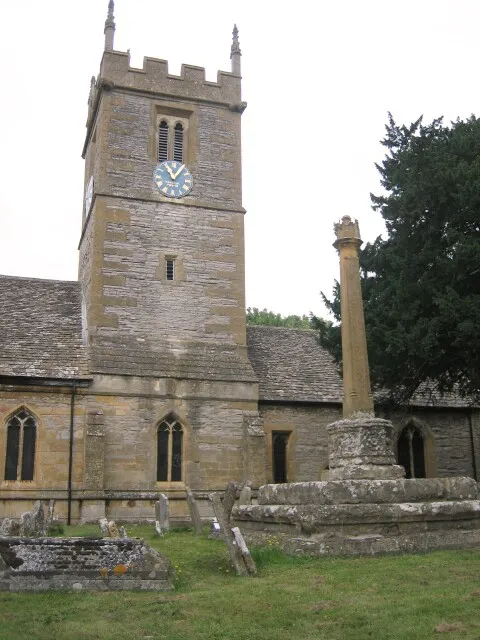 Churchyard cross (right) and central tower (centre left) of St Andrew's parish church, Hampton, Worcestershire, seen from the south