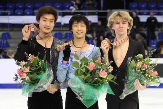 Song Nan (2), Yuzuru Hanyu (1), Artur Gachinski (3) at the 2010 World Junior Figure Skating Championships