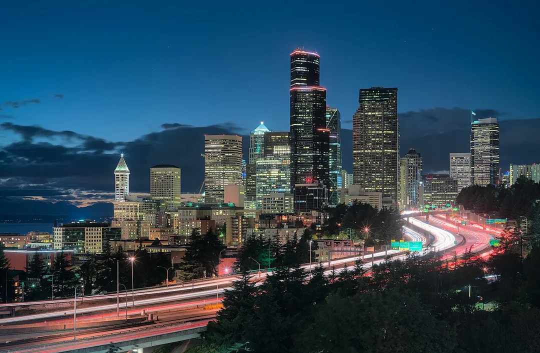 The Seattle skyline at dusk as viewed from the Jose Rizal Bridge. In the foreground is the Interstate 5 in Washington.