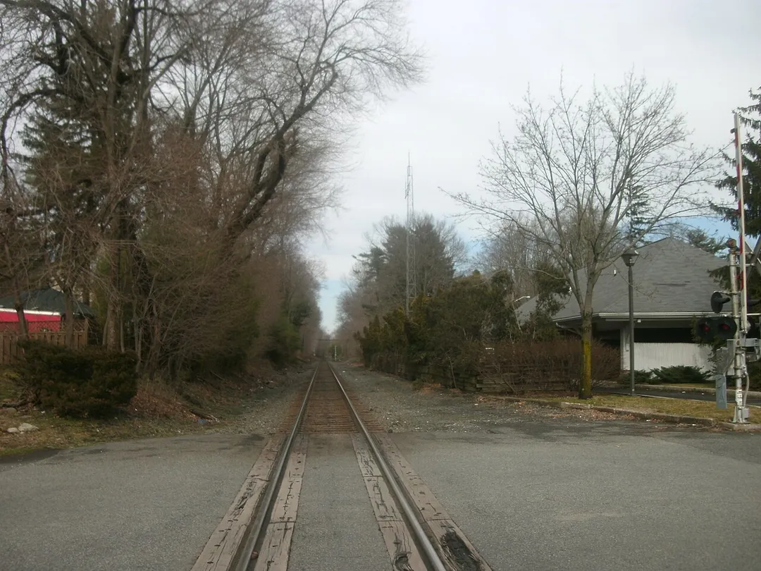 The former station at Harrington Park, New Jersey along the former West Shore Railroad is visible on the east side of the tracks.