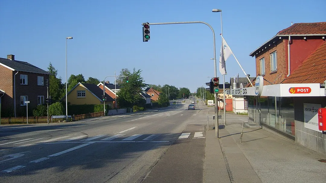 Main road Hovedvejen passing through the center of Hasselager, Denmark