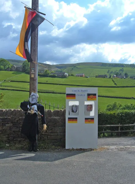 Checkpoint Charlie - Hayfield "Halt! who goes there?". Photo taken on Kinder Road the day after Hayfield's May Queen festivities. Residents decorated their houses and streets on the theme of significant decades. Here the collapse of the Berlin Wall is representing the 1980's.