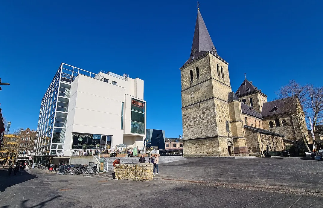 View from Pancratiusplein of Glaspaleis (left) and Sint-Pancratiuskerk in Heerlen, Limburg, the Netherlands.