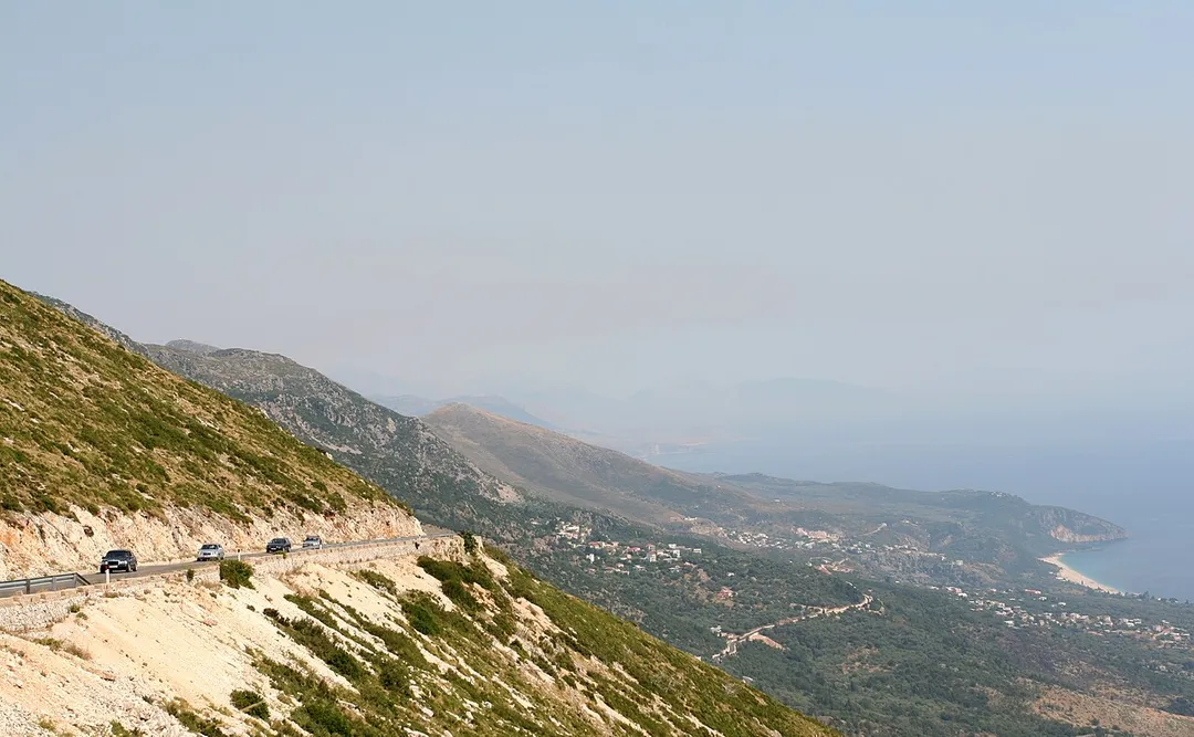 Road on the mountains of the National Park of Llogara looking down on the village of Dhërmi, Himara, Albania