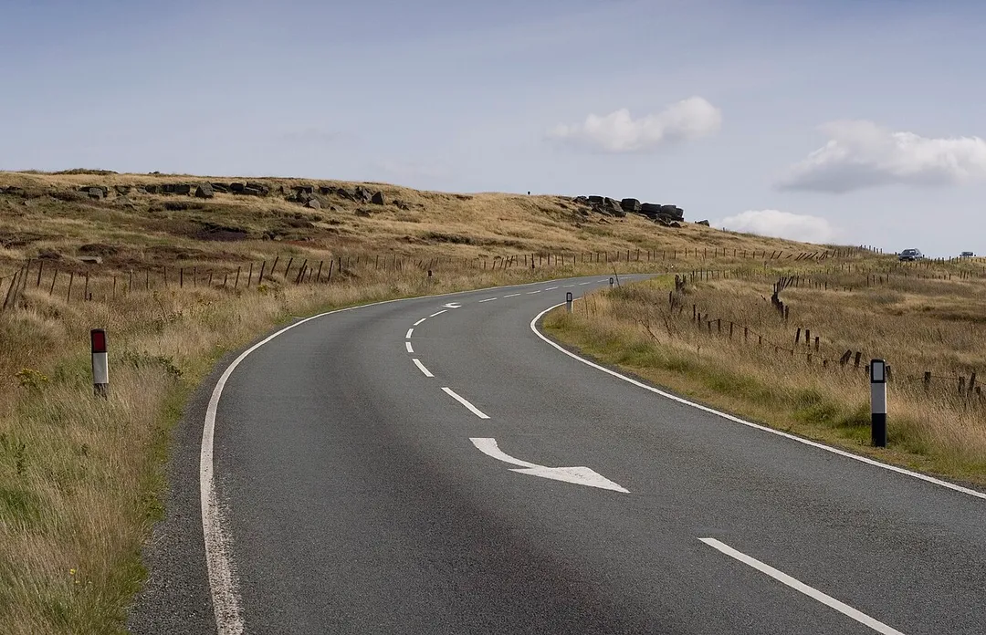 The A635 Holmfirth Road passes by Hollin Brown Knoll on Saddleworth Moor, Saddleworth, Greater Manchester, England.  The rocks in the distance were mentioned by murderer Myra Hindley as visible during the burial of victim Pauline Reade.