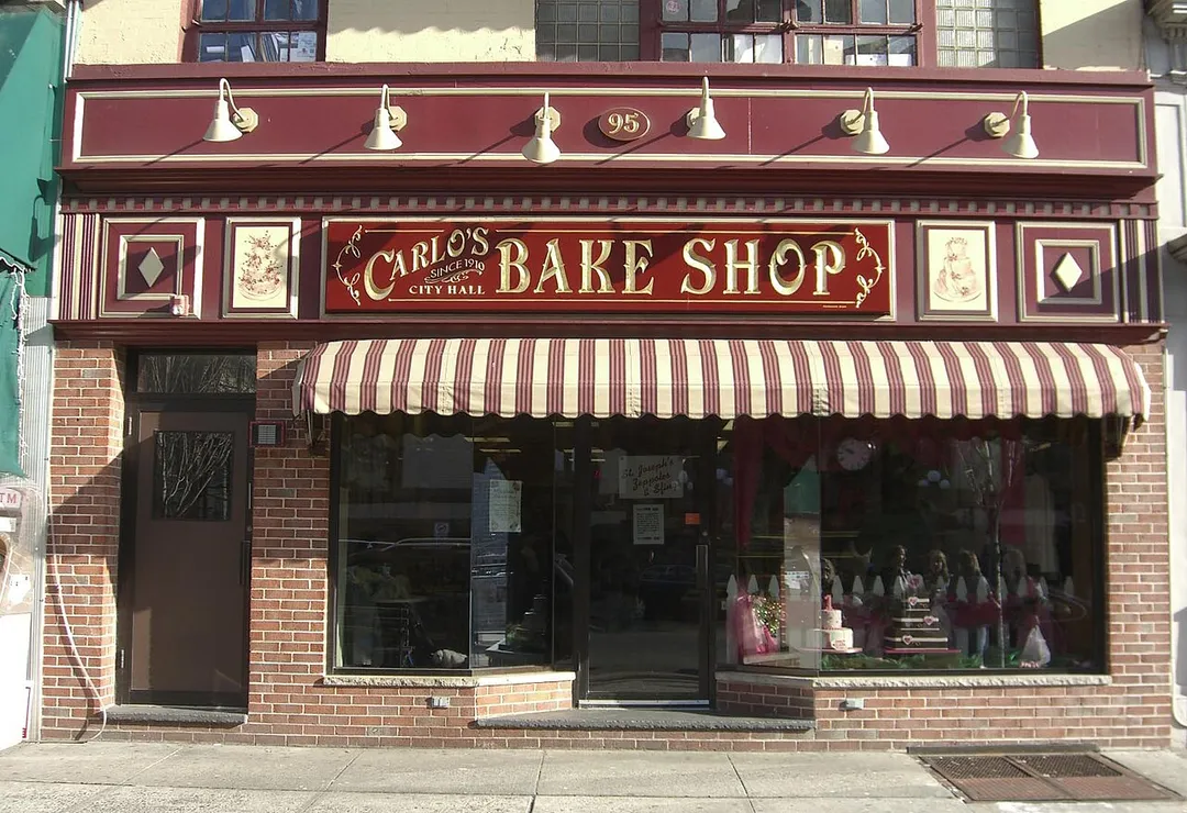 Carlo’s Bake Shop in Hoboken, New Jersey, The shop, which is located on Washington Street between 1st Street and Newark Street, across from City Hall, is the setting for The Learning Channel’s reality television series, Cake Boss. 

This photo was created by Luigi Novi. It is not in the public domain, and use of this file outside of the licensing terms is a copyright violation. If you would like to use this image outside of the Wikimedia projects, you may do so, only if I am properly credited, either by linking the photograph to this page, or with an easily visible credit placed near the photo in each instance in which it is used. Please credit authorship as follows:  © Luigi Novi.  Please maintain the original file name in all uses.
You can see a gallery of some of my other photos 
here. If you have any questions, you can contact me by sending me an email or leaving a note at the bottom of my Wikipedia talk page.