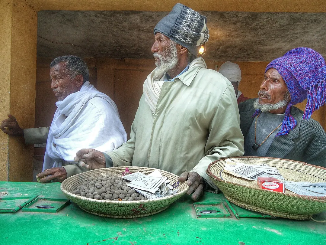 The picture is taken inside Tsion church found in Aksum in April, 2013. Tsion church is believed to be the place where Arc of the covenant is found.
I found three old men giving away 'emnet' which was kept on a 'sefed tray'  to people who came to attend Palm sunday known in Ethiopia as 'Hosaena'.  Hosaena is celebrated to remember the journey Juseus took to Jerusalem. It falls on a sunday found before Easter.

 'Emnet' is given in Ethiopian orthodox church and it is prayed on and people usually put it on top of a painful area in their bodies or use it to feel safe and protected by God.