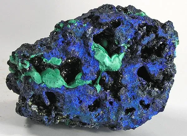 Azurite, Malachite
Locality: Kabwe Mine (Broken Hill Mine), Kabwe (Broken Hill), Central Province, Zambia (Locality at mindat.org)
Size: 8.9 x 5.9 x 3.3 cm.
You read that right - a rare specimen of azurite not from Broken Hill in Australia but from the same-named locality in ZAMBIA! This is basically a series of small pockets with little sparkly crystals in them - with accenting light green malachite here and there. Probably from the 1950s-1960s.