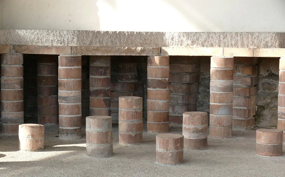 Reconstruction of hypocaust in Augusta Raurica (Augst).
Augusta Raurica is a large Roman archaeological site and an open-air museum in Switzerland. Located on the south bank of the Rhine river about 20 km east of Basel near the villages of Augst and Kaiseraugst, it is the oldest known Roman colony on the Rhine.

A hypocaust (Latin hypocaustum) is an ancient Roman system of central heating. The word literally means "heat from below", from the Greek hypo meaning below or underneath, and kaiein, to burn or light a fire.