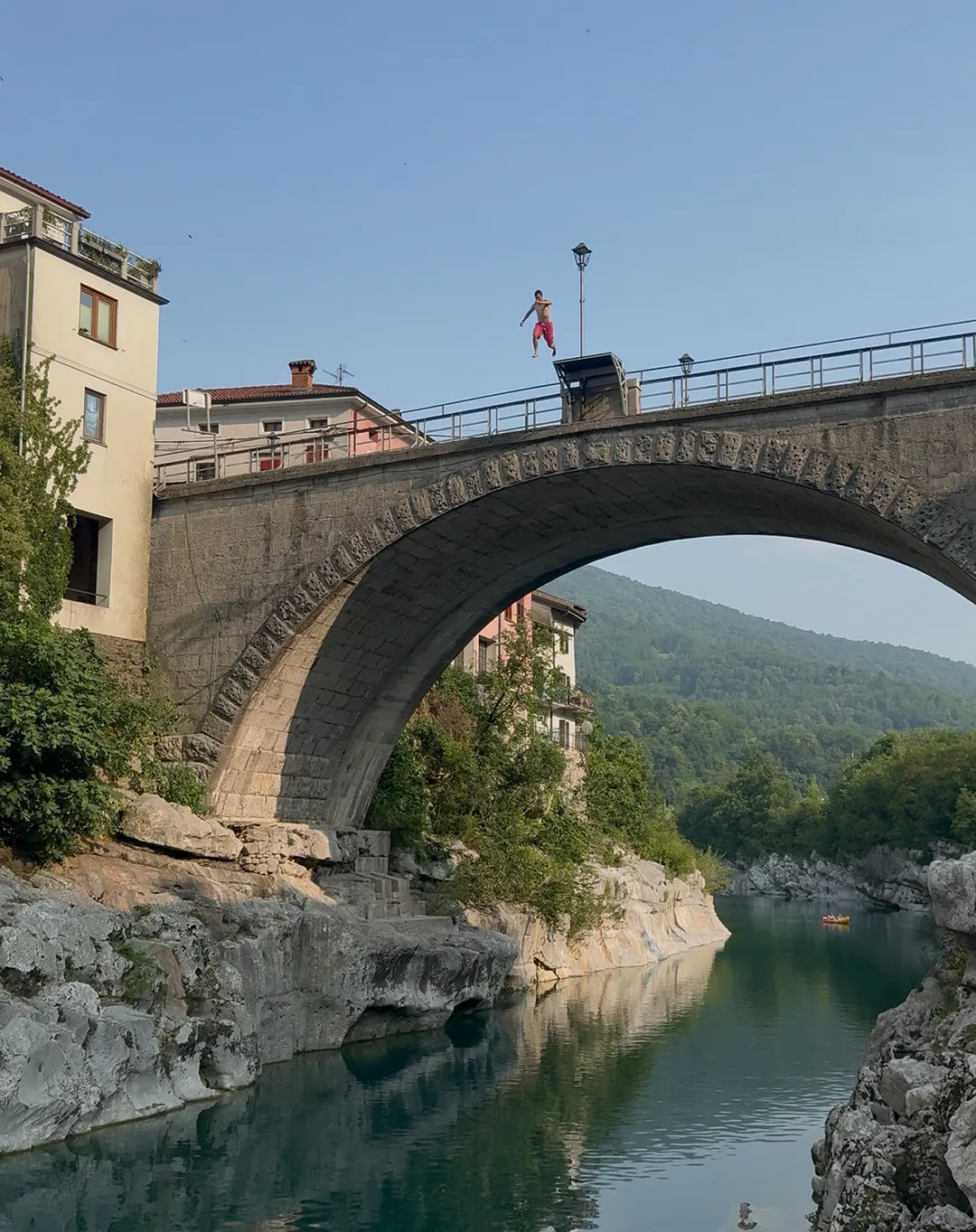 Travelers jumping off the famous Kanal bridge in Slovenia