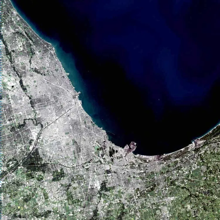 Despite being named after the Algonquian word for skunk, Chicago is one of America’s most thriving and spectacular cities. Spanning 22 miles along the southwest shore of Lake Michigan, the city itself holds nearly 2.9 million people and sits in the center of a metropolitan area containing more than 8 million.
Looking at the image, some of Chicago’s famous sites can be made out. The long black line coming into the center of the city from the southwest is the Chicago Sanitary and Ship Canal. In the center of the city, just right of where the canal banks north to become the Chicago River, sits a small pier on Lake Michigan, perpendicular to the city, known as Meigs Field. Just to the left of the pier is Soldier Field. Scanning north of Meigs Field, another pier juts out onto the lake. This is Navy Pier. Though it cannot be made out in the image, the Water Tower District and the John Hancock Building sit between Navy Pier and the Chicago River. South of this area is downtown Chicago and the Sears Tower.
This simulated-color scene was acquired by the Landsat 7 Enhanced Thematic Mapper plus (ETM+) on September 14, 2001.
  

”The purpose of NASA's Earth Observatory is to provide a freely-accessible publication on the Internet where the public can obtain new satellite imagery and scientific information about our home planet. The focus is on Earth's climate and environmental change. In particular, we hope our site is useful to public media and educators. Any and all materials published on the Earth Observatory are freely available for re-publication or re-use, except where copyright is indicated. We ask that NASA's Earth Observatory be given credit for its original materials.”