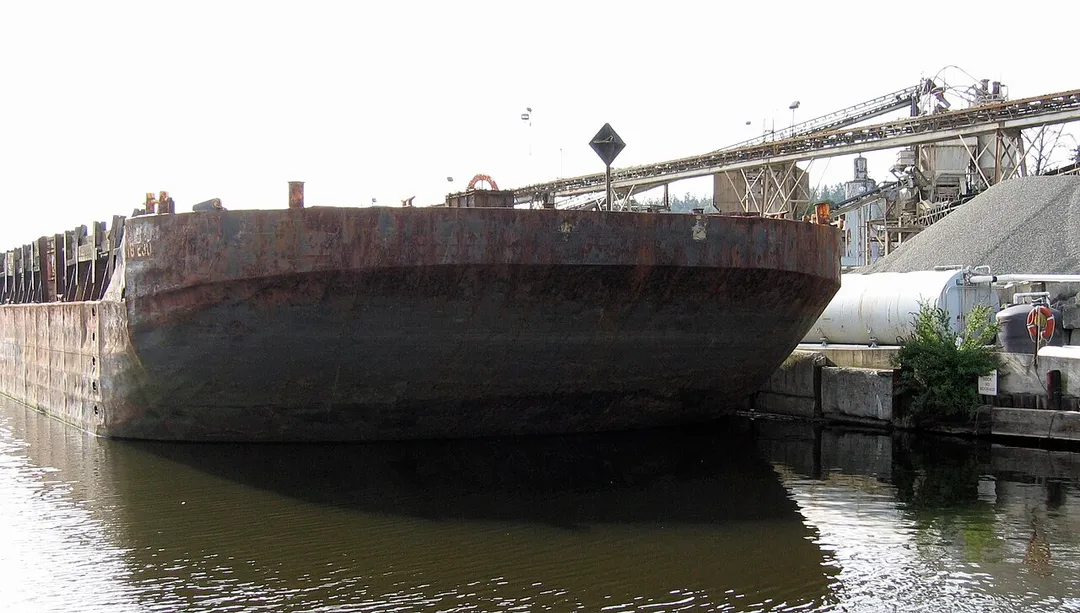 Image by me (Dara Korra'ti/Dawnstar Graphics) of a cement barge offloading materials to Kenmore Ready-Mix in Kenmore, Washington.