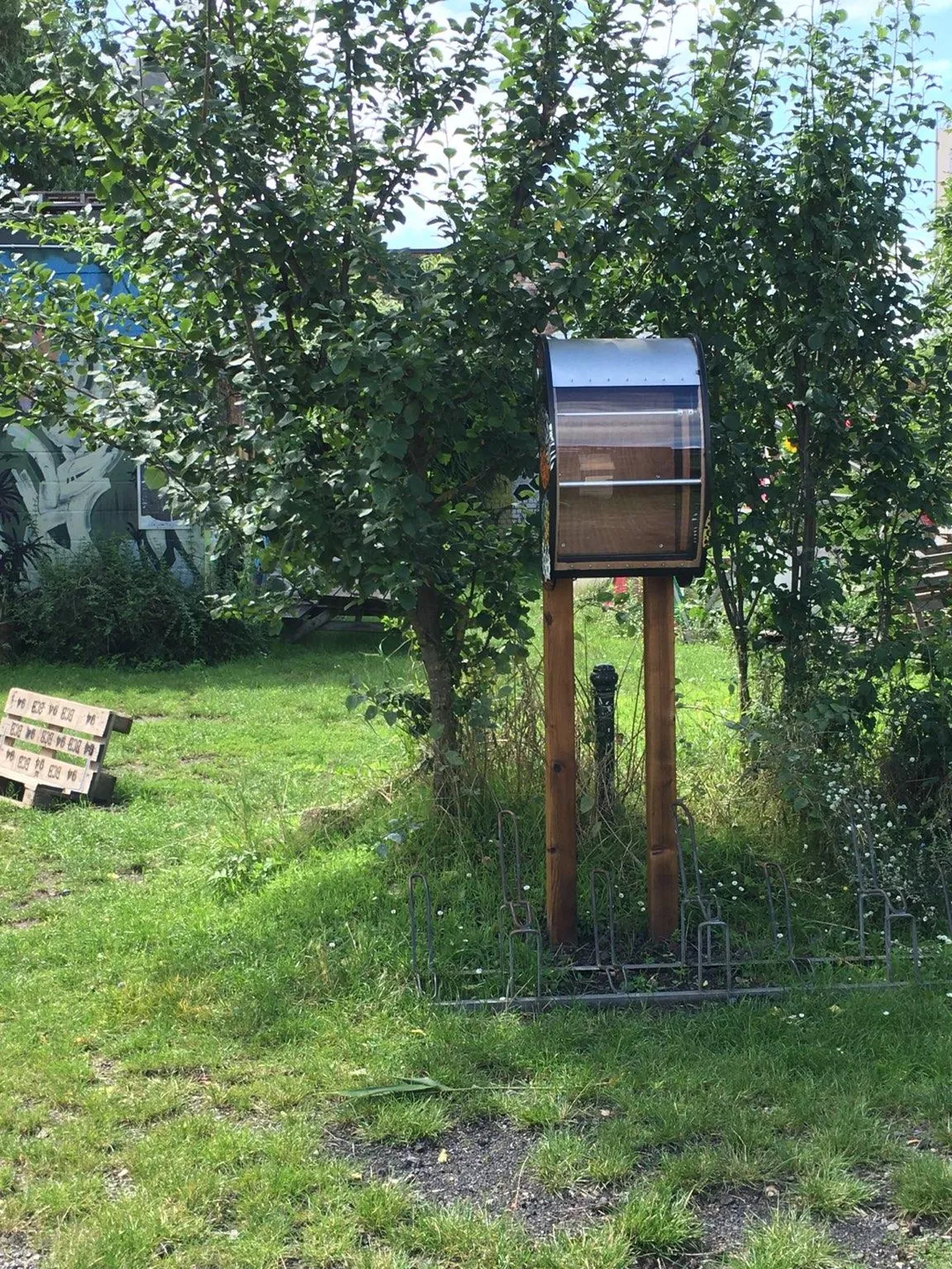 Empty wooden public bookcase close to the Jeugdhuis Sojo in Kessel-Lo, Belgium.