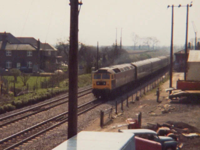 Former Kidlington stationA class 47 with a Poole-Manchester train passes Kidlington station (already closed when this was taken in 1980, and has now disappeared altogether with a housing development and industrial buildings).
For more recent views of the same location, see SP4814 : Bridge over the railway at Kidlington and SP4814 : Kidlington railway station (site), Oxfordshire; the latter shows that the station visible in this photo has now gone.