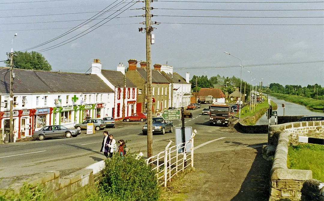 Leaving Kilcock on N4, the main road to Dublin.
View eastward, towards Maynooth and Dublin. On the right is the Royal Canal, which runs from the River Shannon at Termonberry, near Longford (Co. Westmeath) all the way to Dublin, and here forms the boundary between Cos. Meath and Kildare. (Note the lock-gate beams on the right). (This was before the M4 motorway was built).