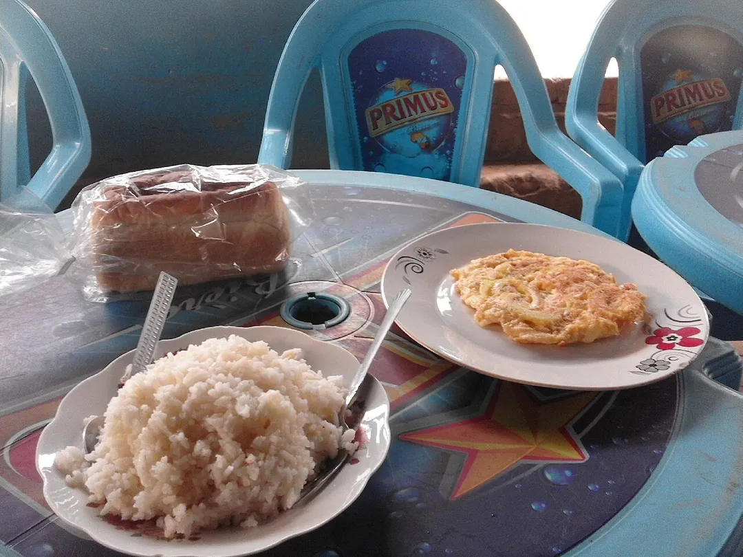 Rice, fried eggs and bread in restaurant in Kimpese, DRC