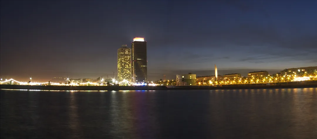 At the left, the Port Olímpic de Barcelona, at the center, the high rises Hotel Arts and Torre Mapfre, and at the right, buildings of the Olympic Village.