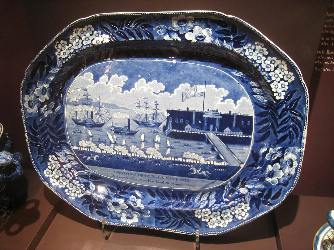 Platter, pearlware with transfer-printed decorations; James and Ralph Clews, Cobridge, Staffordshire, circa 1825. Inscription: "Landing of General Lafayette at Castle Garden, New York 16 August 1824". Pottery exhibited in the DAR Museum, National Society Daughters of the American Revolution, 1776 D Street NW, Washington, DC, USA.